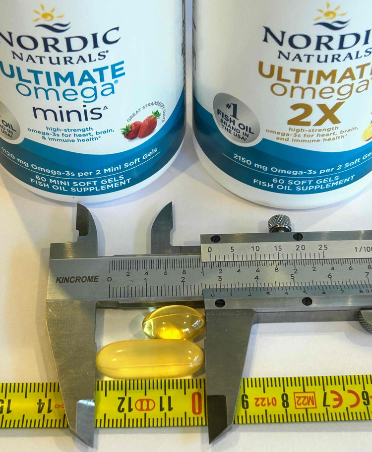 Two bottles of Nordic Naturals Ultimate Omega supplements with a ruler and measuring tape for scale.