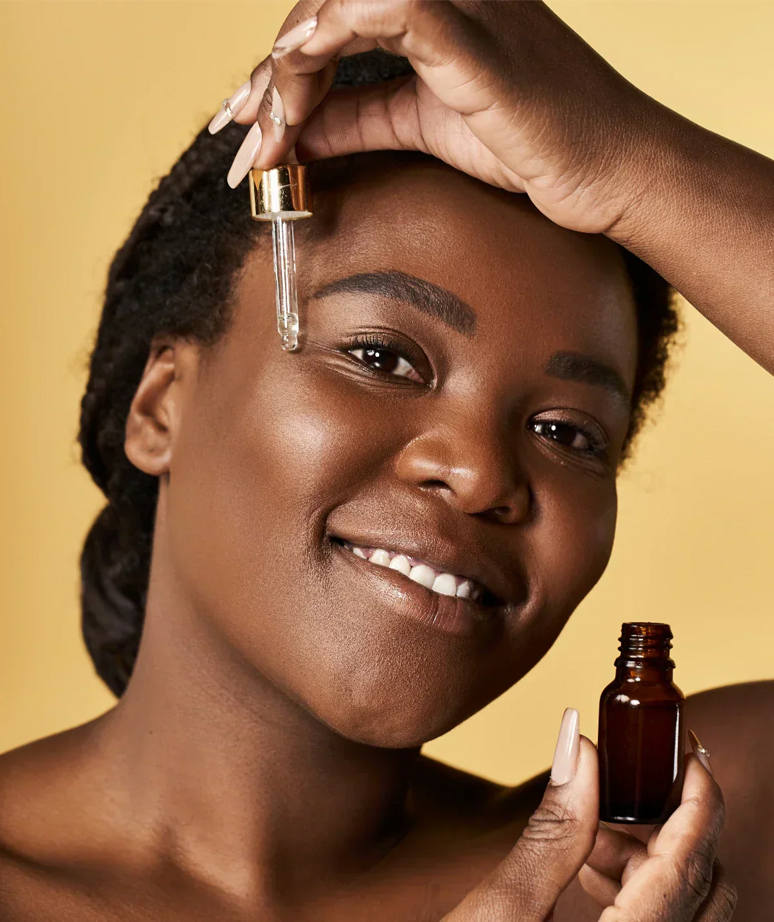 Woman using a pipette to apply neem oil to skin