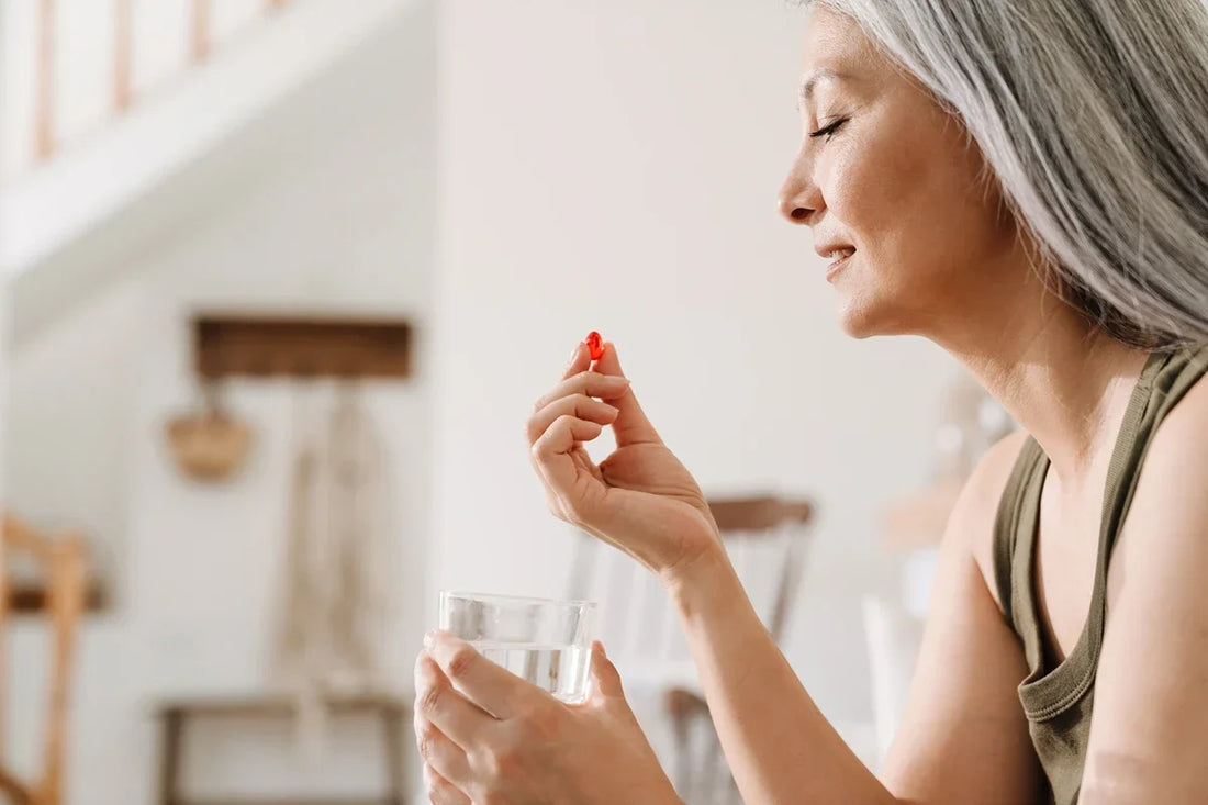 Older woman taking a supplement