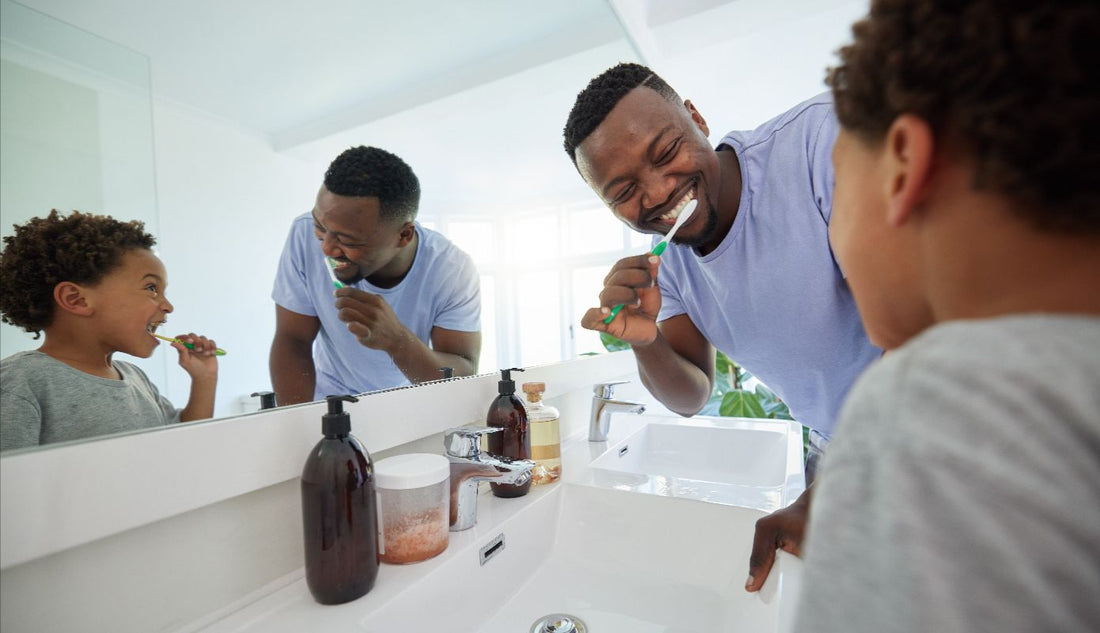 Father and child from NZ brushing their teeth who use Blis Throat Guard in their oral routine