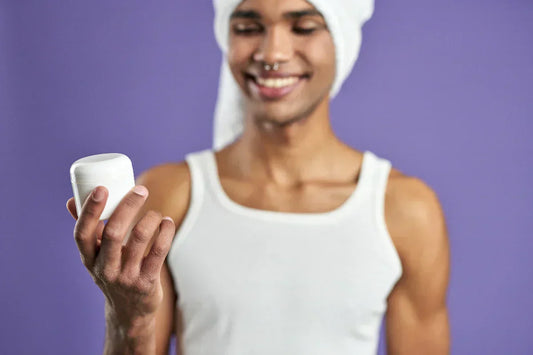 Person looking at bottle and wondering is deodorant bad